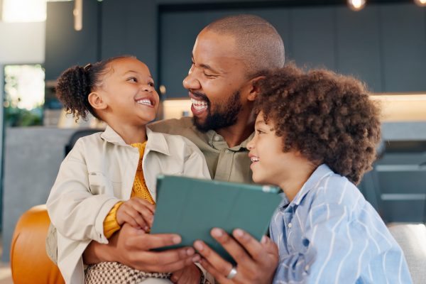 Laughing, movie and tablet with family in living room of home for bonding, entertainment or love. App, social media or streaming with happy father and children in apartment for subscription service